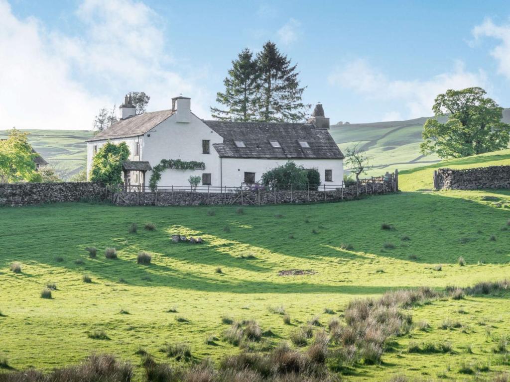 a house on a hill with a green field at 5 Bed in Kendal 88095 in Skelsmergh