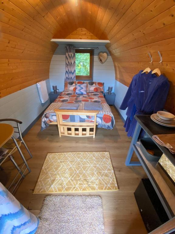 a bedroom with two beds in a cabin at luxury pod with hot tub in Clodock