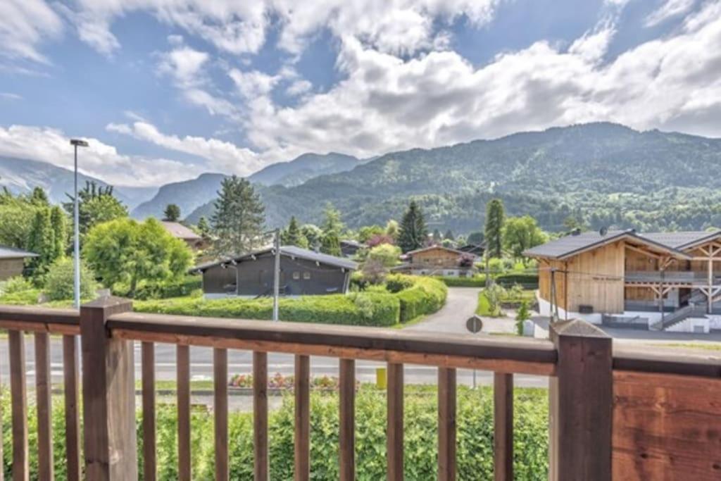 a view from the deck of a home with mountains in the background at Le Chardon Argenté T4 Duplex 7 couchages - Parking in Samoëns