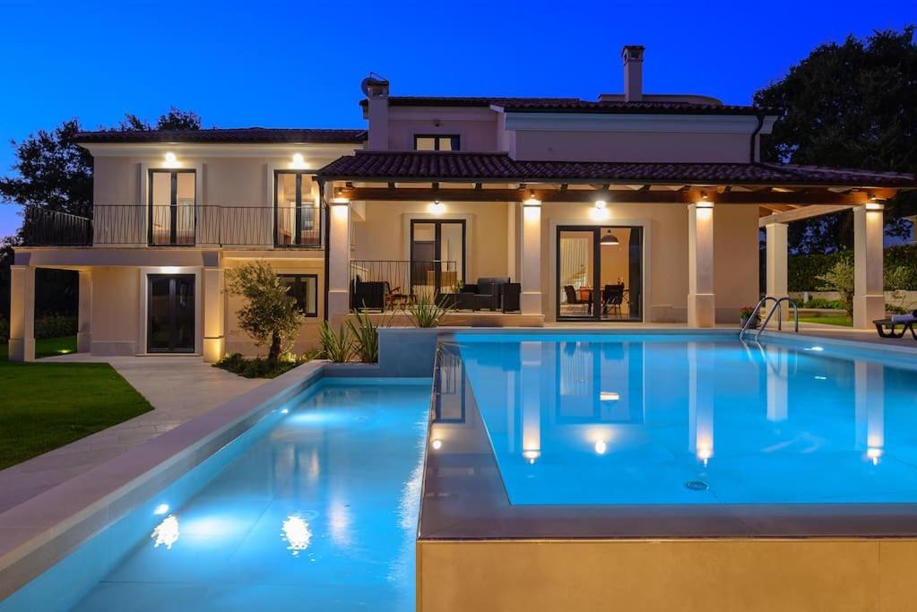 a large swimming pool in front of a house at Villa Fierra by IstriaLux in Svetvinčenat