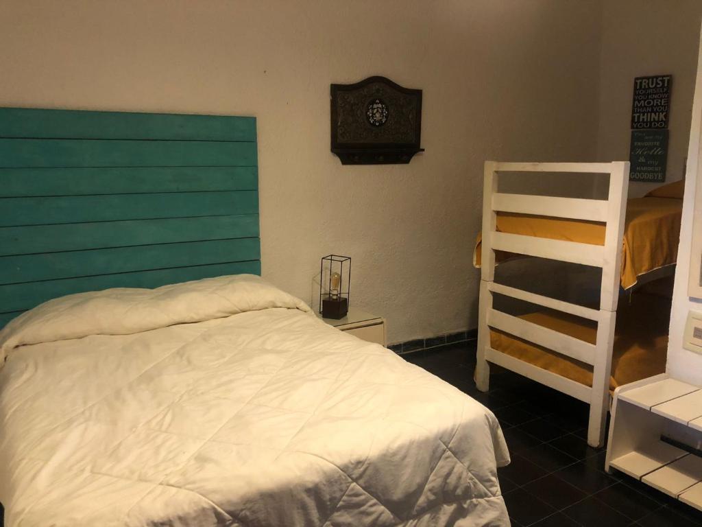 a bedroom with a bed and a clock on the wall at Amaaral in Rocha