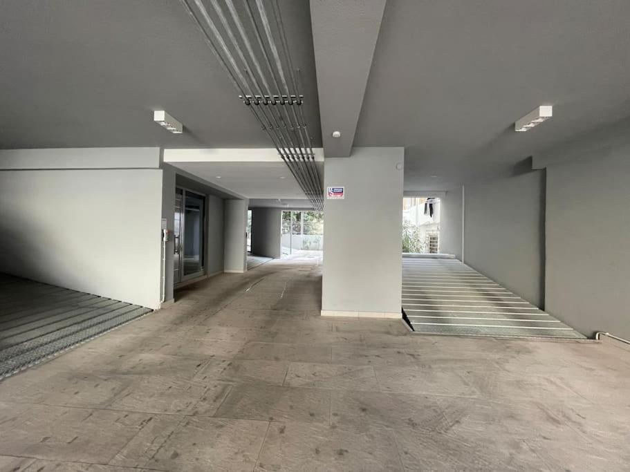 an empty hallway with white walls and wood floors at Luxury Maisonette with Shared Pool in Athens