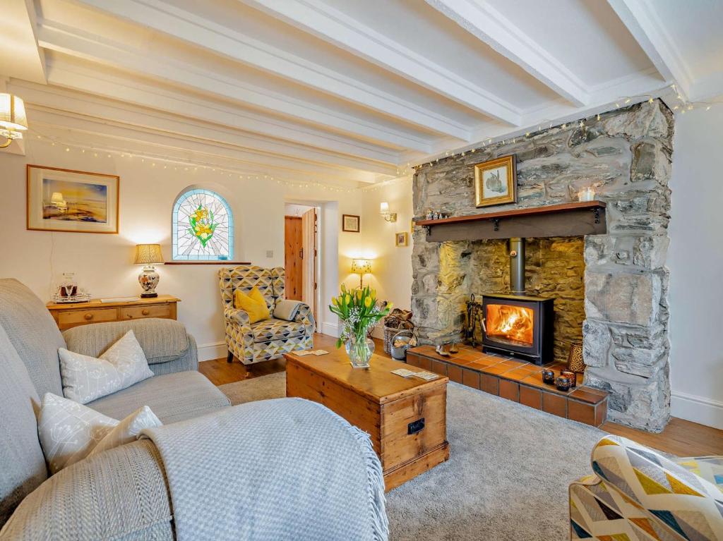 a living room with a large stone fireplace at 2 Bed in Bethesda 66276 in Llanddeiniolen