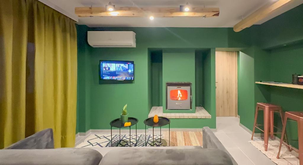 a living room with a couch and a tv on the wall at Theoni Luxury Apartment in Kalavrita