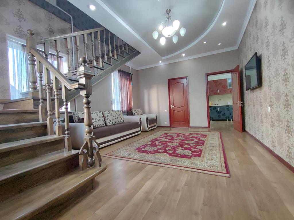 a living room with a staircase and a couch at Archa Hostel in Bishkek