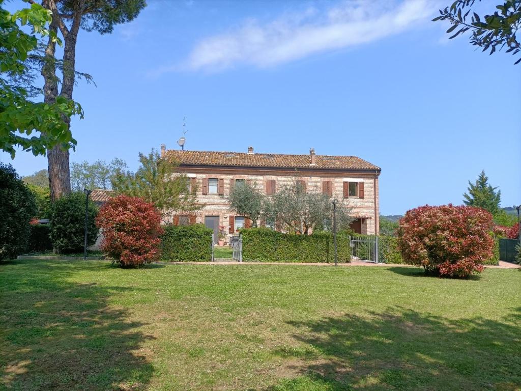 ein großes Haus mit einem Hof davor in der Unterkunft Casolare 1898 in Pesaro