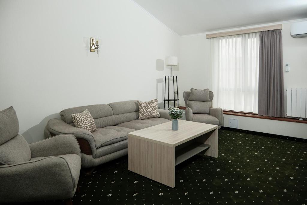 a living room with a couch and a coffee table at Colette Hotel in Yerevan