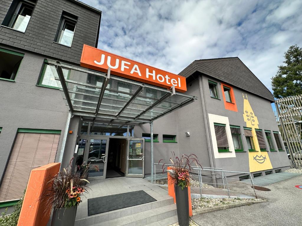 ein jiricanisches Hotel mit einem Schild auf dem Gebäude in der Unterkunft JUFA Hotel Graz Süd in Graz