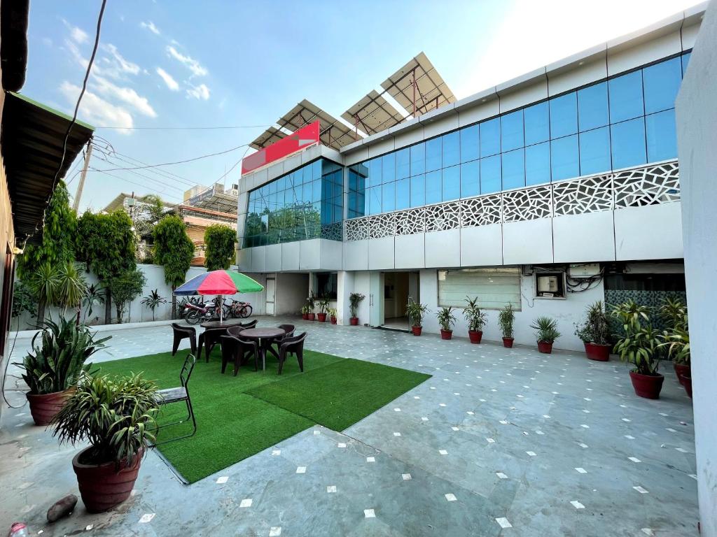 a building with a patio with a table and chairs at MALAYA HOUSE --Couples, Family, Corporate Favorite-- Near BMC Chowk ICONIC Mall in Jalandhar