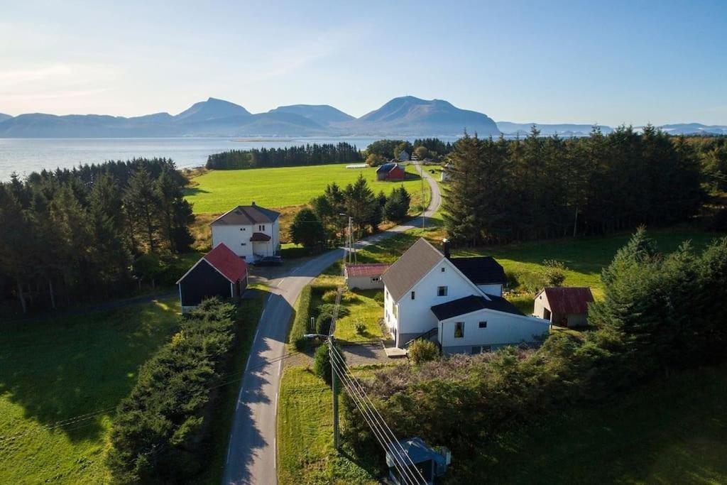 an aerial view of a farm with a road and houses at Haus auf der Insel Skuløya in Ålesund