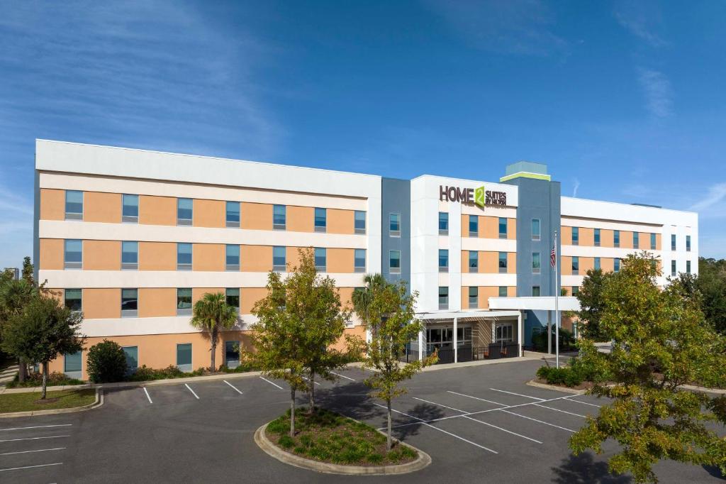 an office building with a parking lot in front of it at Home2 Suites by Hilton Tallahassee State Capitol in Tallahassee