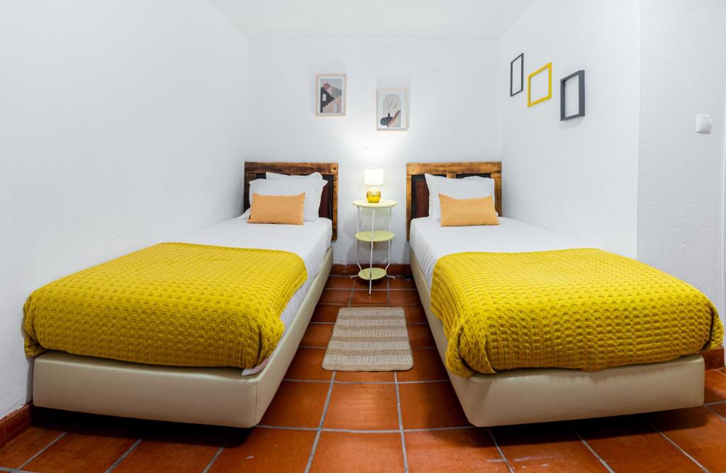 two beds sitting next to each other in a room at VILA NATURA in Barreiro