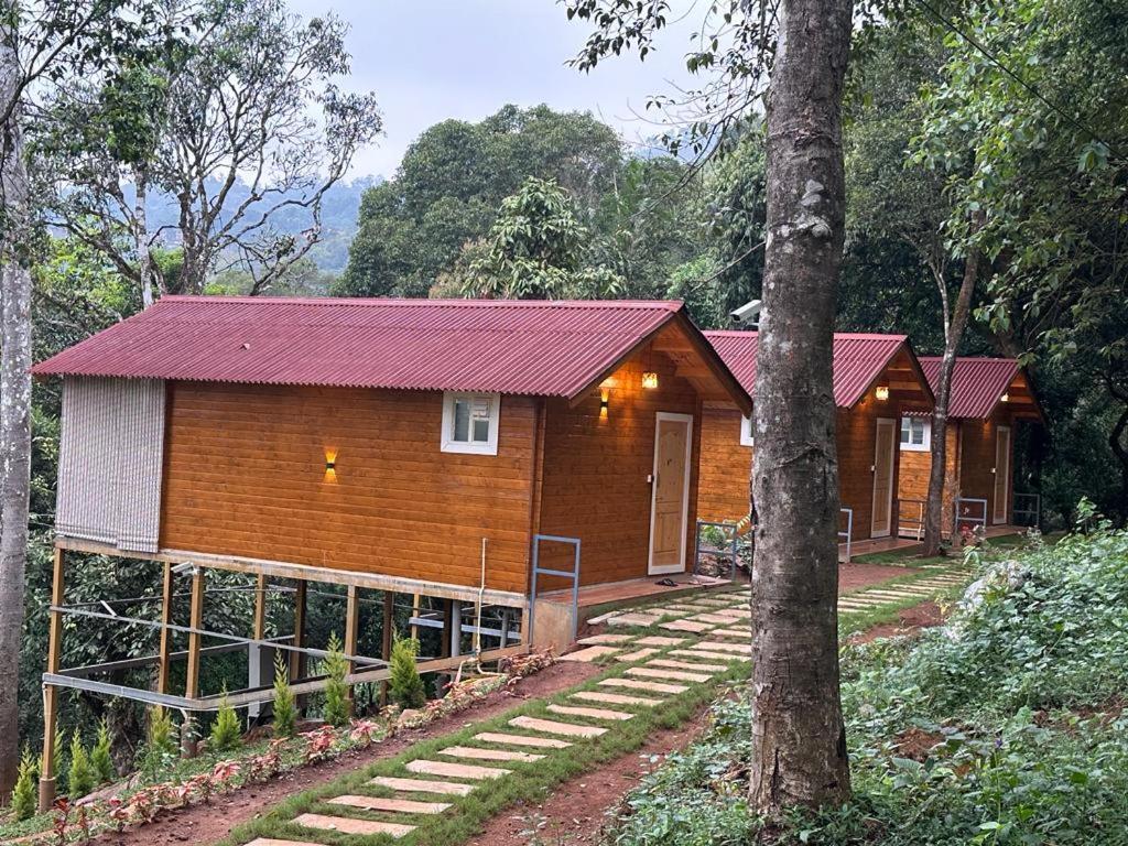 a wooden cabin in the middle of a forest at Coorg Jungle Mist in Madikeri