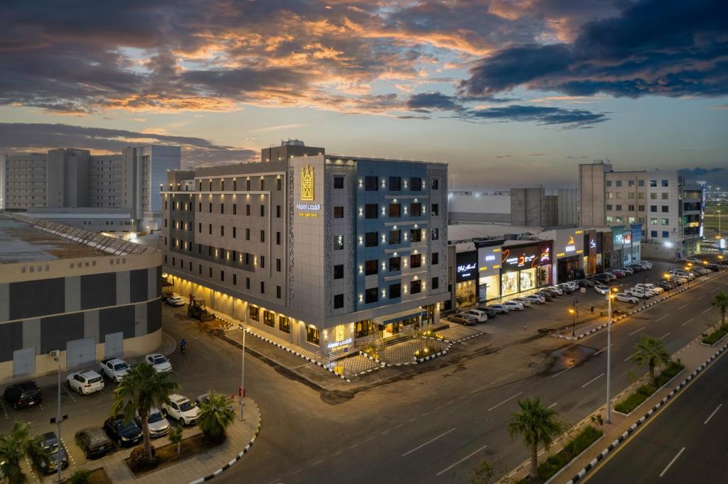 a large building in a city with a parking lot at القصر الكورنيش in Jazan