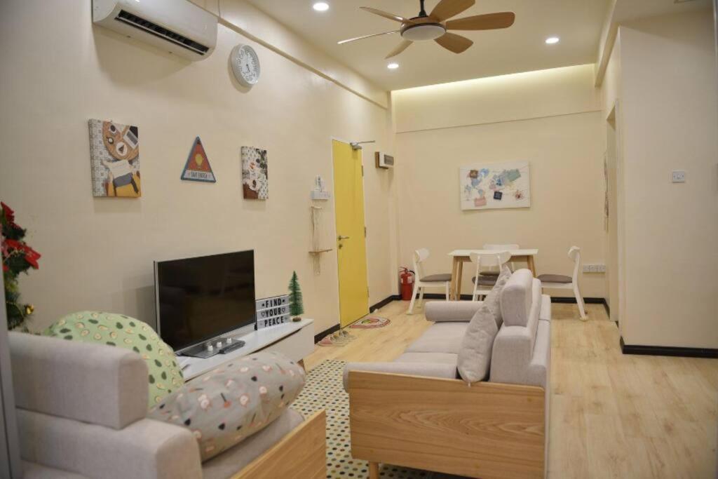 a living room with two couches and a fireplace at Your home away from home. in Sandakan