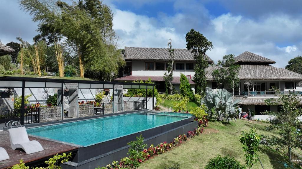 a swimming pool in the backyard of a house at Blanket Days Resort and Spa in Thekkady