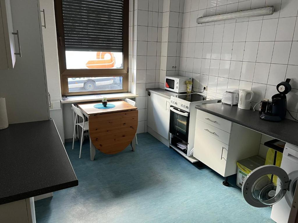 a small kitchen with a table and a microwave at Schicke Monteurunterkunft in Mendig mit drei Wohneinheiten in Mendig