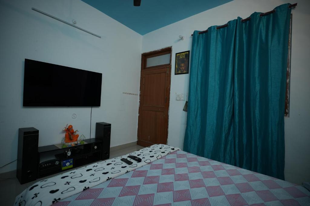 1 dormitorio con 1 cama y TV de pantalla plana en Hill crest Kb Restaurant banquet, en Kota Bāgh
