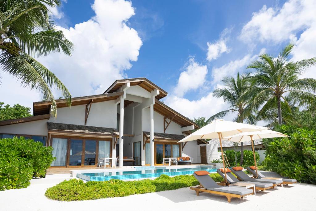 a villa with a swimming pool and a resort at Emerald Faarufushi Resort & Spa - Deluxe All Inclusive in Raa Atoll