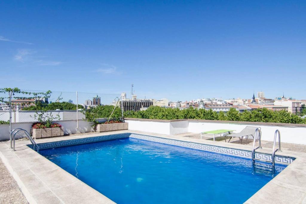 a swimming pool on the roof of a building at Brigth- Pool Parking-1Bd 1Bth-Prado in Madrid