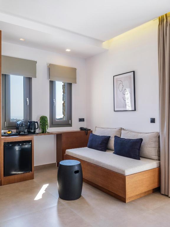 a living room with a bed and a tv at Villa Evi & Suites in Mikonos