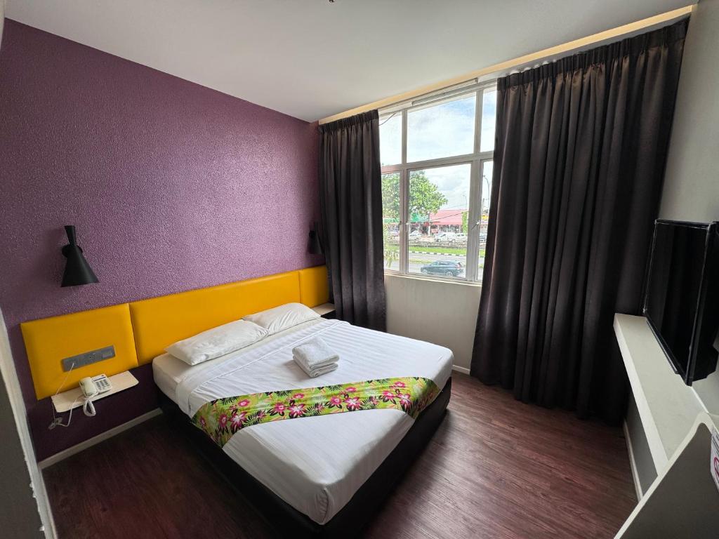 a hotel room with a bed and a window at Win Win Boutique Hotel PD in Port Dickson