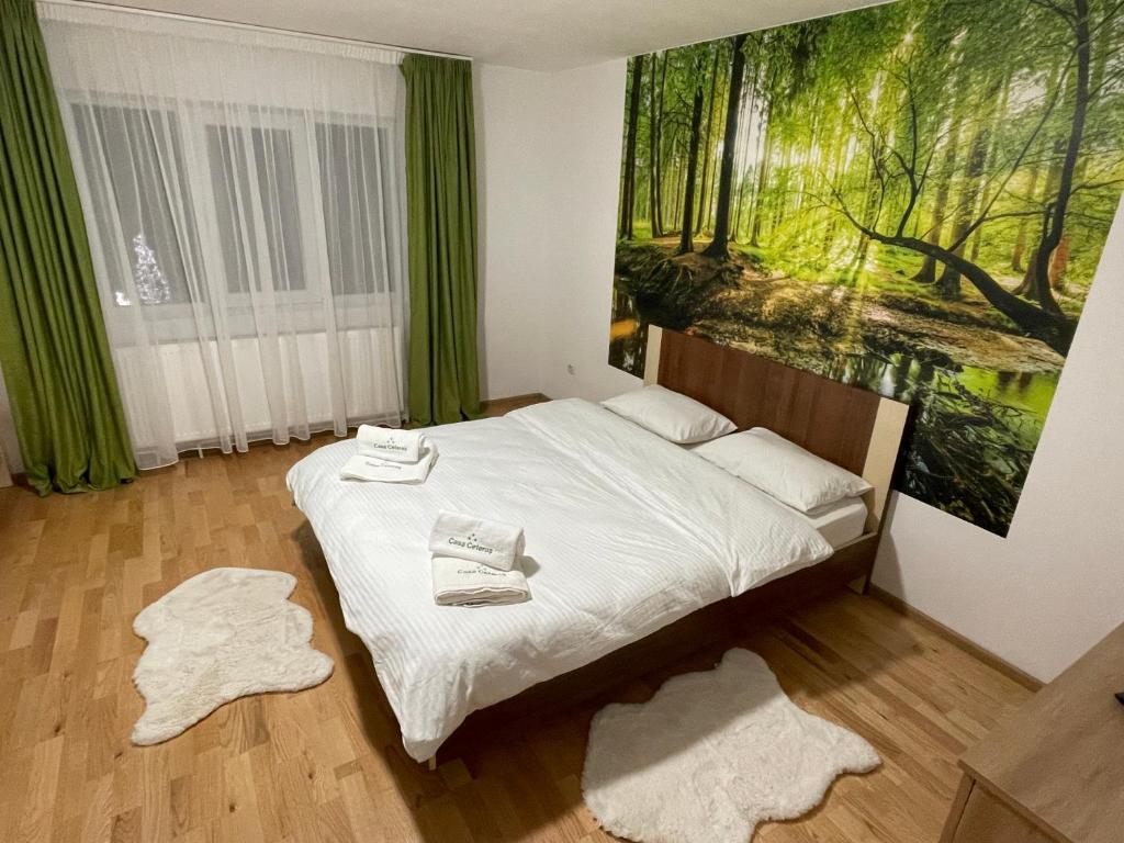 a bedroom with a bed with towels on it at Casa Ceteras in Cavnic