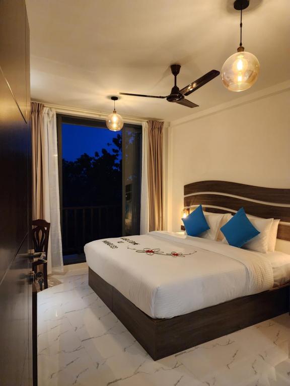 a bedroom with a large bed and a window at Nikabliss Dhigurah in Dhigurah