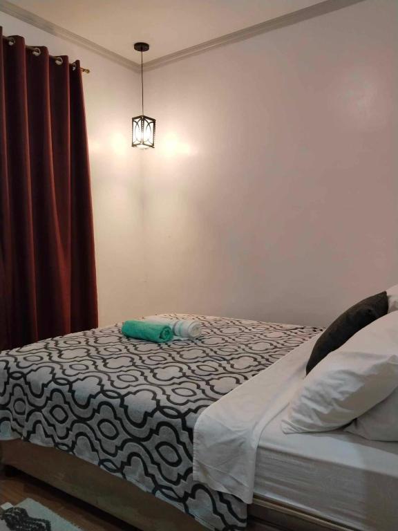 Voodi või voodid majutusasutuse Mannah Garden Staycation Place toas