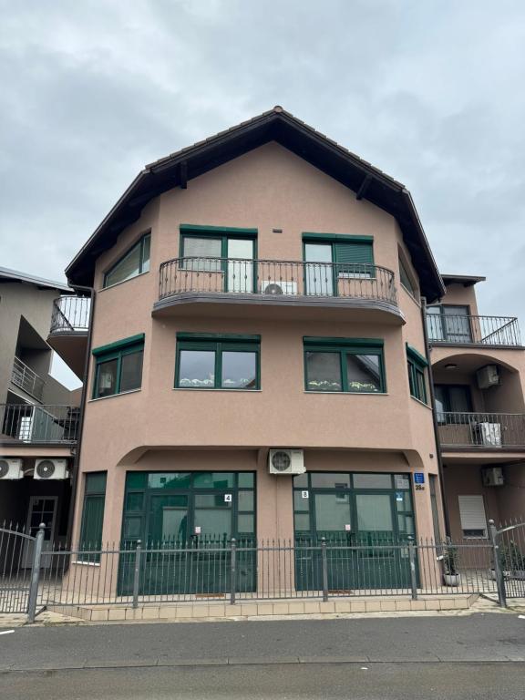 a large apartment building with a gambrel roof at Rooms Fitea in Osijek