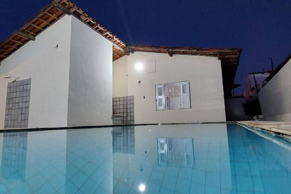 a swimming pool in front of a building at night at Casa no Jardim Renascença- Bird House Renascença in São Luís
