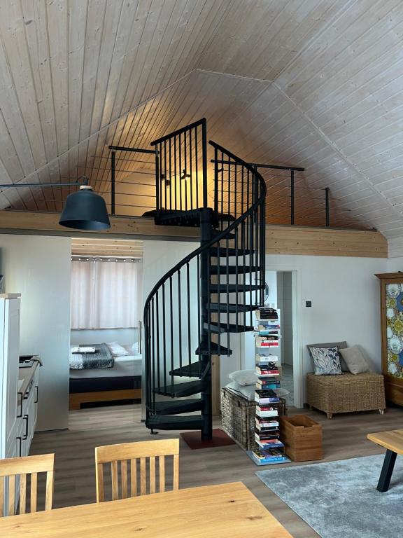 a living room with a spiral staircase in a house at großzügige Ferienwohnung mit weitem Ausblick in Lichtenberg