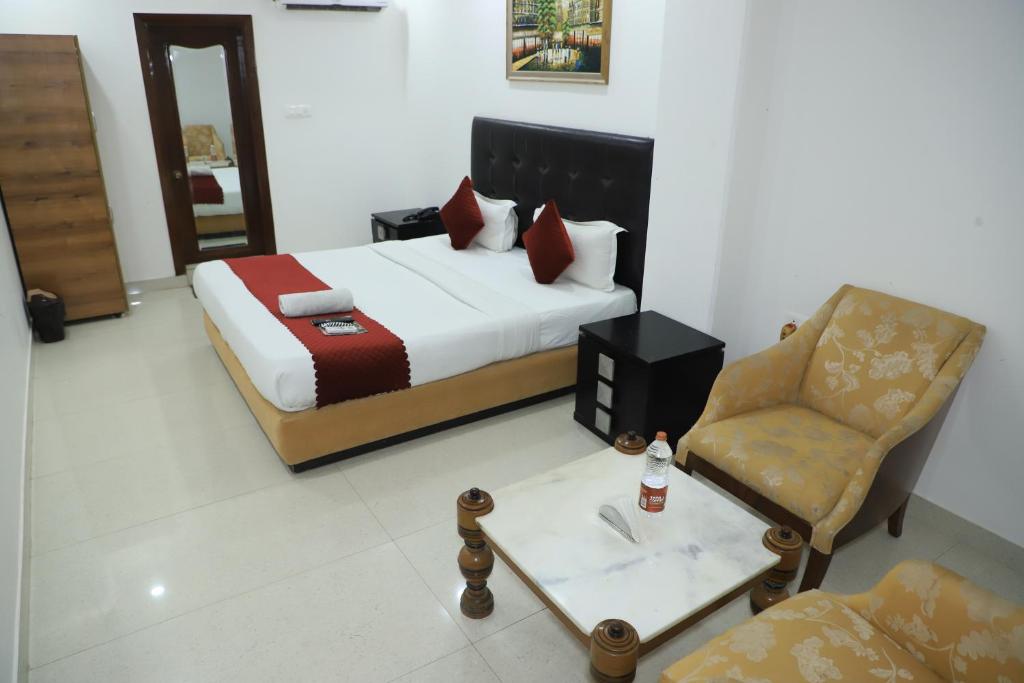 um quarto de hotel com uma cama e uma cadeira em Hotel Moon Residency Near Yashobhoomi Convention Centre em Nova Deli