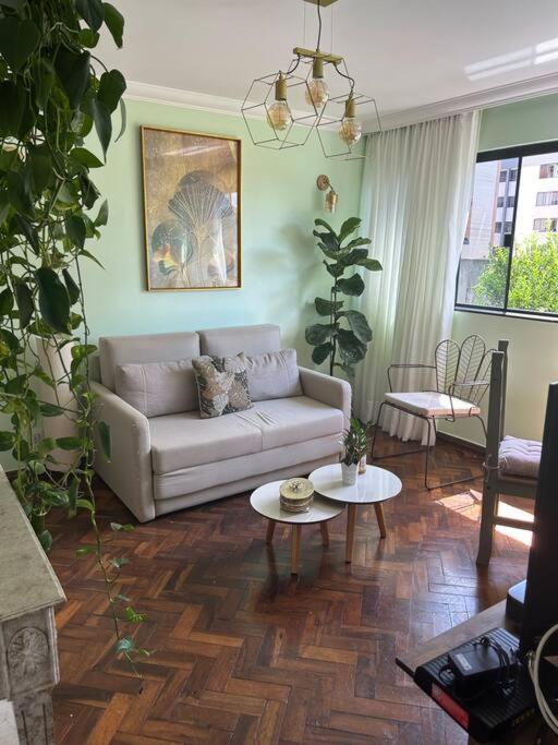 a living room with a couch and tables in it at Casa de Ana - no coração de Bsb! in Brasília