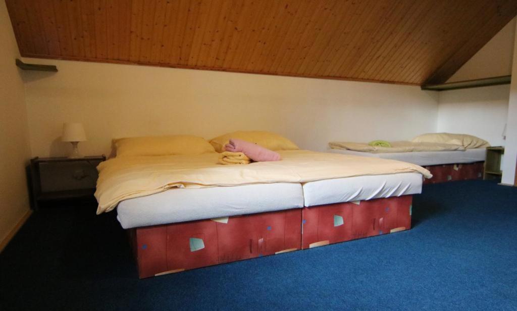 two twin beds in a bedroom with a teddy bear on them at Penzion Zoom in Albrechtice v Jizerských horách