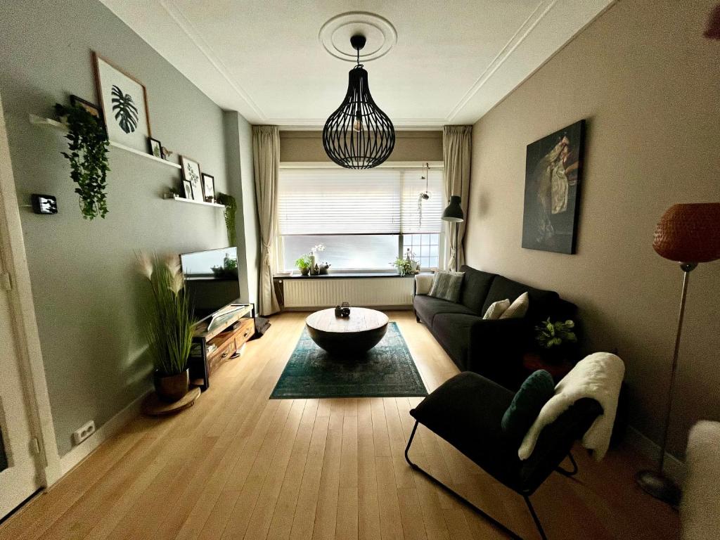 een woonkamer met een bank en een tafel bij Gezellige benedenwoning Singel in Dordrecht