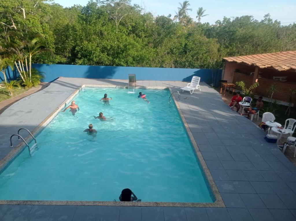 a group of people swimming in a swimming pool at Hotel Mata Atlântica in Corumbau