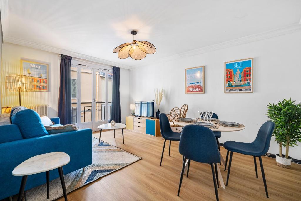 a living room with a blue couch and a table at NICE RENTING - PHILIBERT - Elegant Spacious Quiet Near the Port Free Parking in Nice