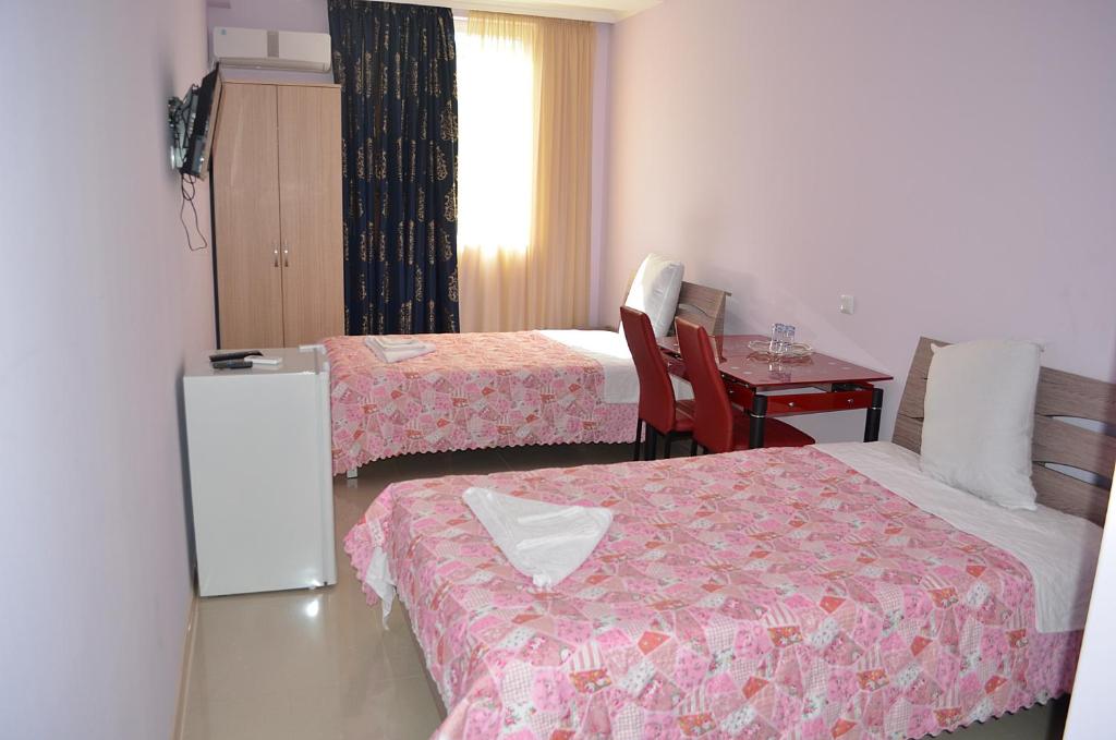 Postel nebo postele na pokoji v ubytování Hotel Okriba