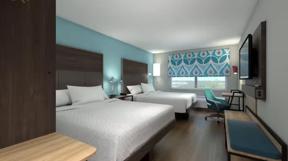 um quarto de hotel com duas camas e uma televisão em Tru By Hilton Lincoln East em Lincoln