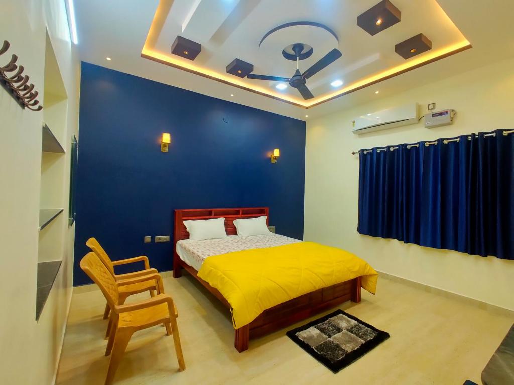 a bedroom with a bed and a blue wall at Little Dream Homestay Hampi in Hampi