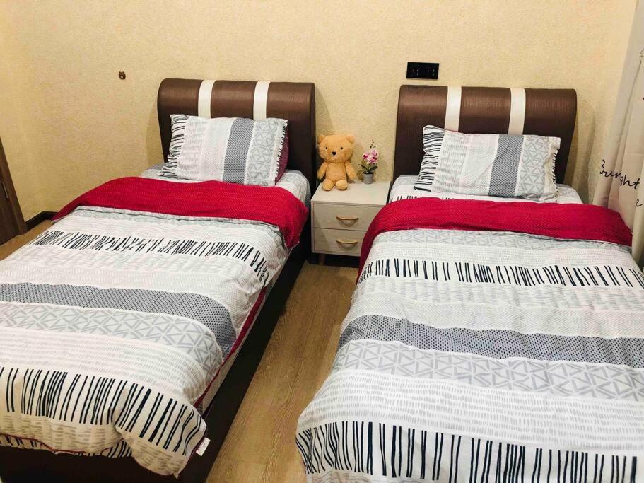 Postel nebo postele na pokoji v ubytování Kota Kinabalu Four Seasons Homestay 沙巴亚庇四季小屋