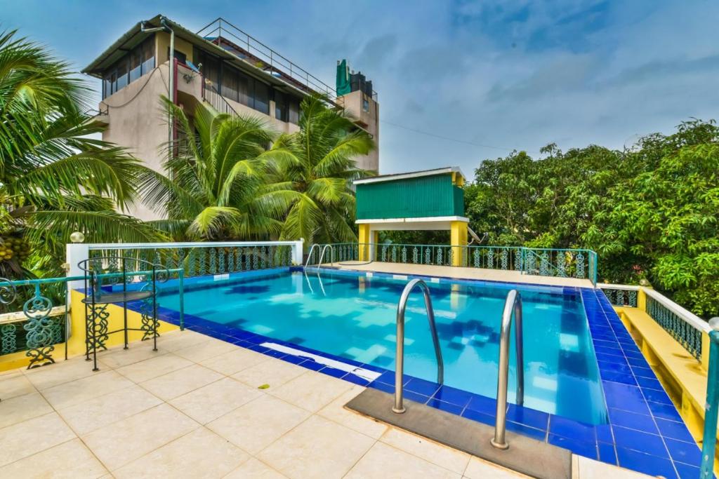 a swimming pool on the side of a building at 2 BHK beach goan villa with pool calangute in Calangute