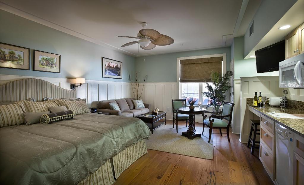 a bedroom with a bed and a living room at The Inlet Sports Lodge in Myrtle Beach