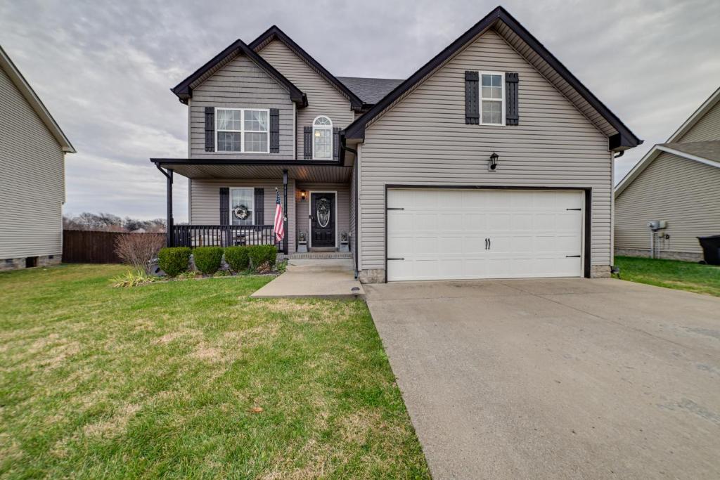 a large house with a white garage at Family-Friendly Clarksville Home with Fire Pit! in Oak Grove