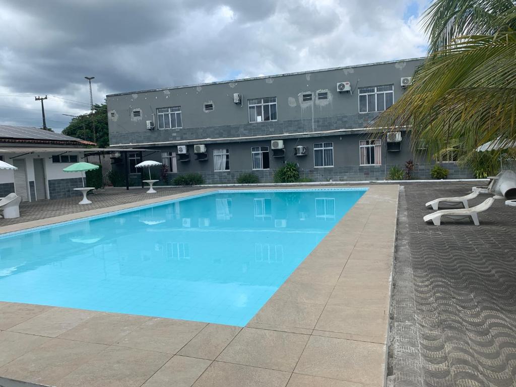 a large swimming pool in front of a building at Hotel Turístico de Alagoinhas in Alagoinhas