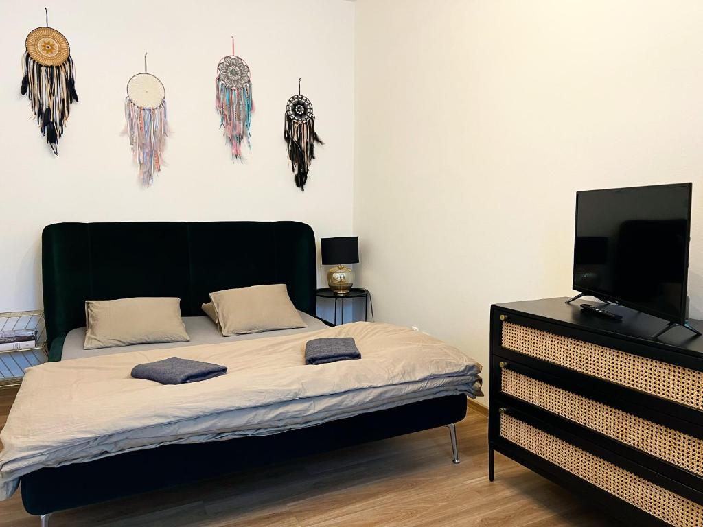 a bedroom with a bed and a flat screen tv at Sušilova 14 apartments III in Přerov
