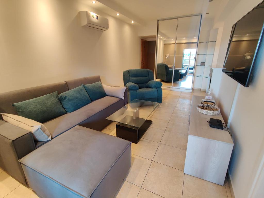 a living room with a couch and two chairs at Maestro II Apartment in Larnaka
