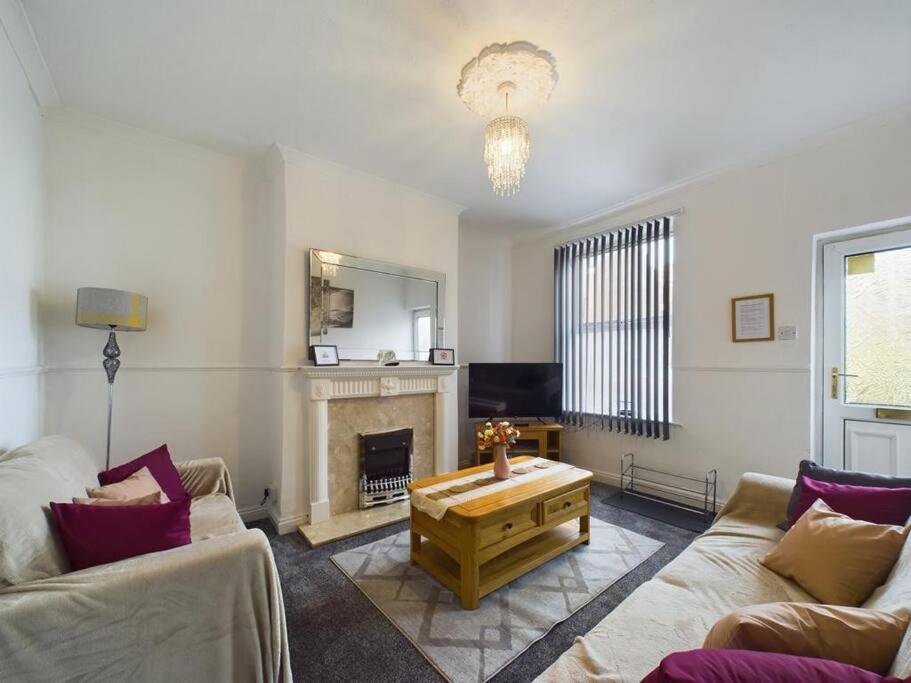 a living room with a couch and a coffee table at Cozy Hull House near City Centre - Walkable to the Deep in Hull