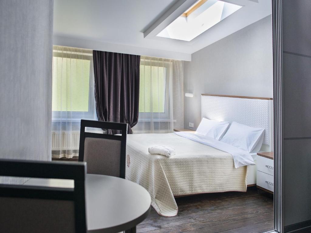 a bedroom with a bed and a table and a mirror at Apart Hotel Kvartira 1 in Odesa
